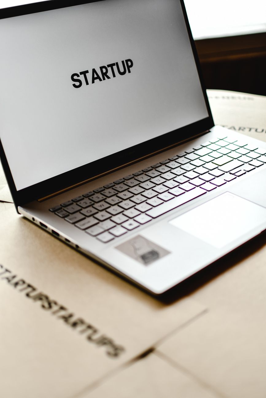 African tech hub with young innovators working on laptops and screens