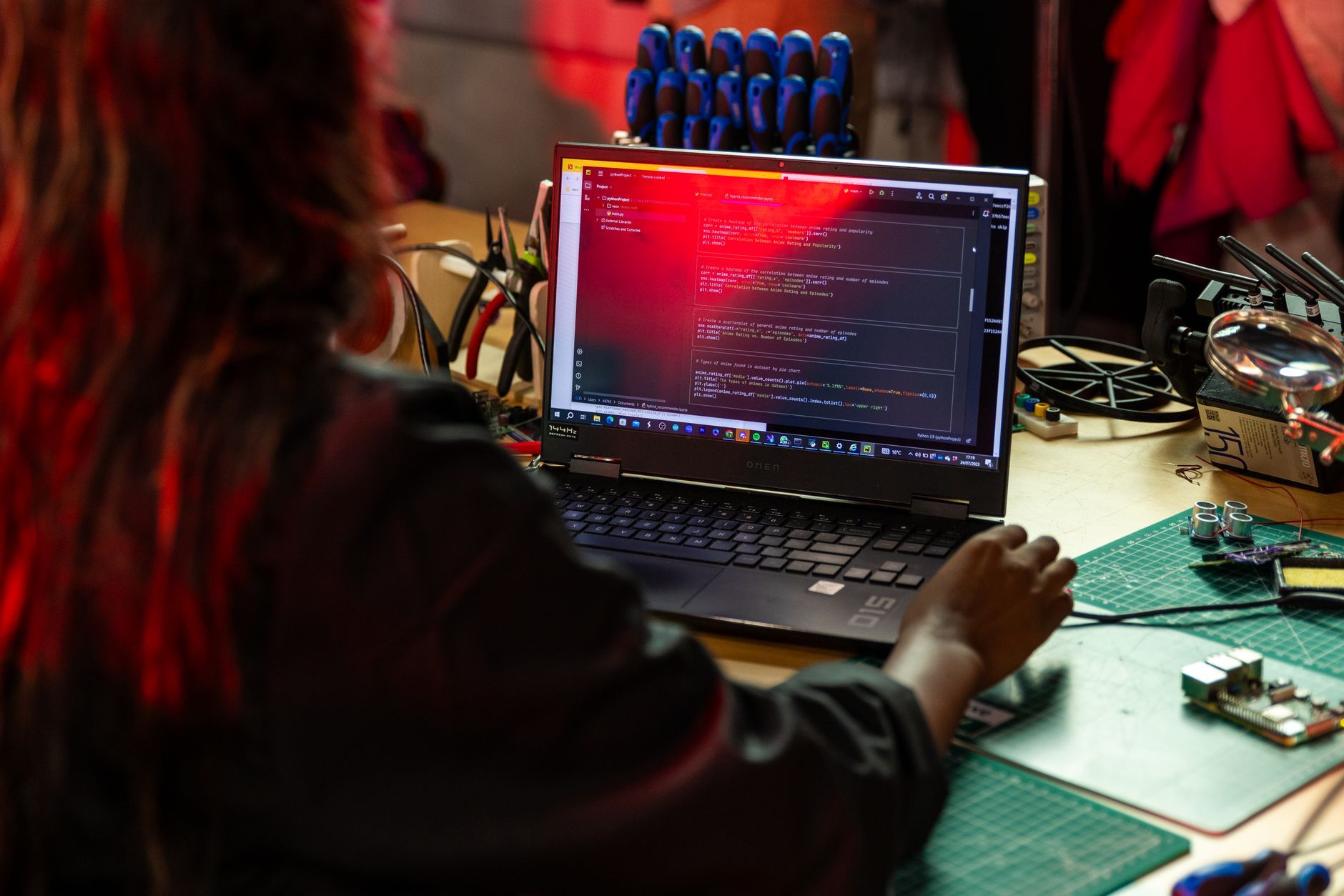 African developer writing AI code on a laptop in a modern office