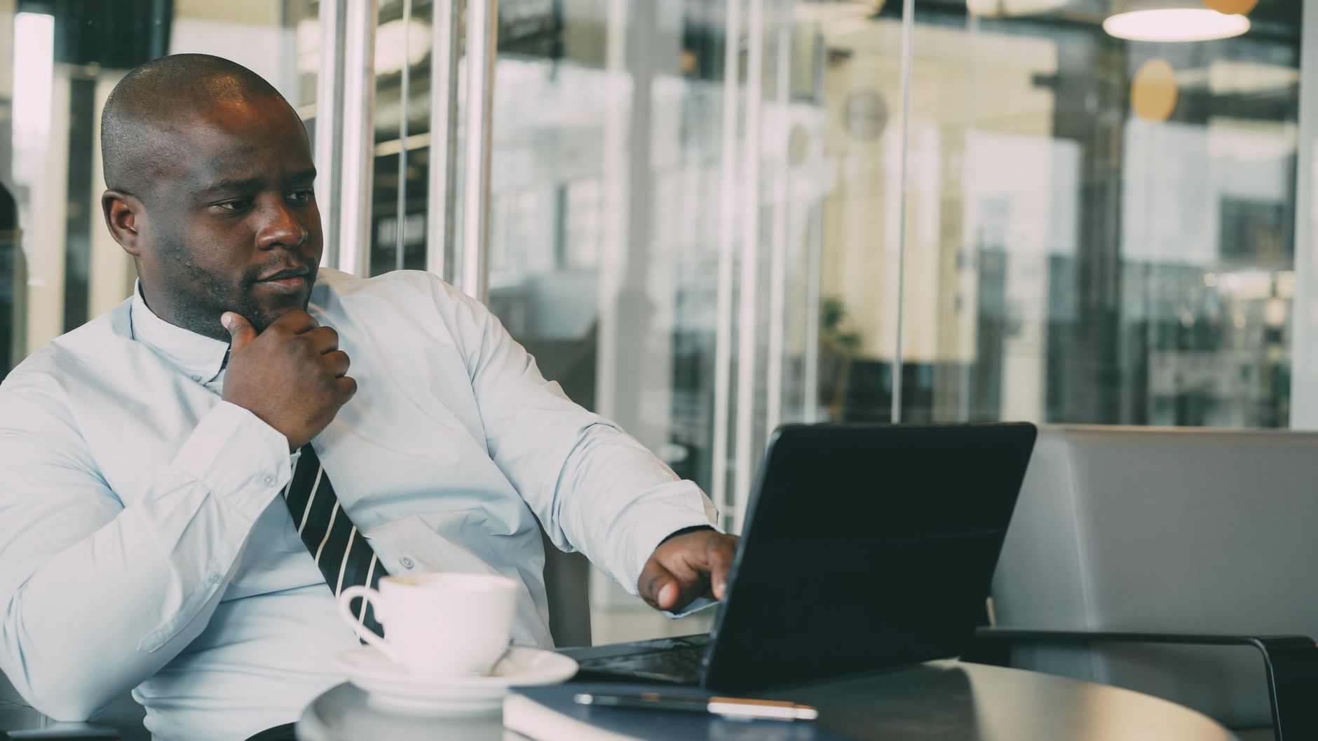 African entrepreneur using laptop for social media strategy planning