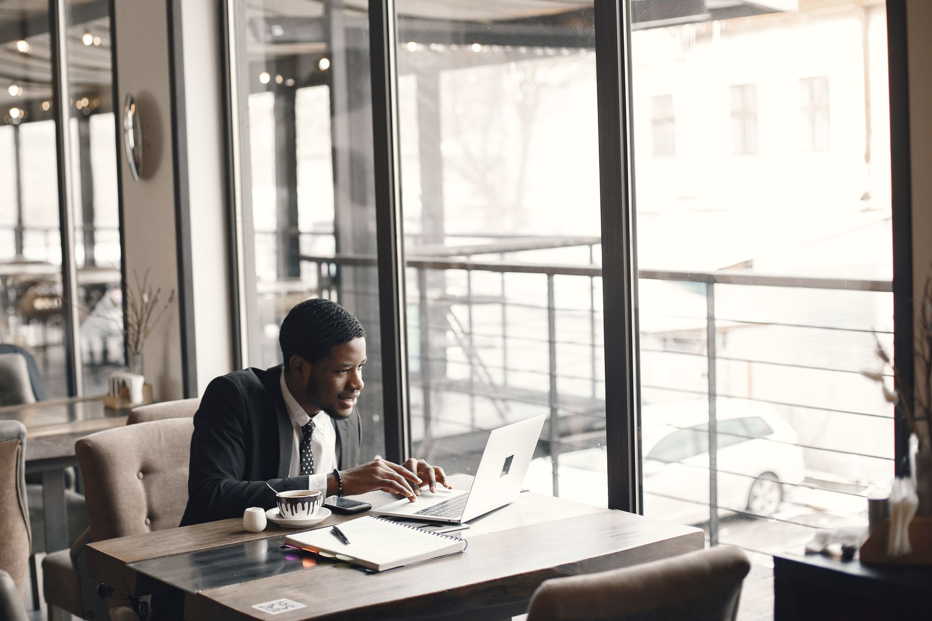 African entrepreneurs collaborating around a laptop in a modern co-working space