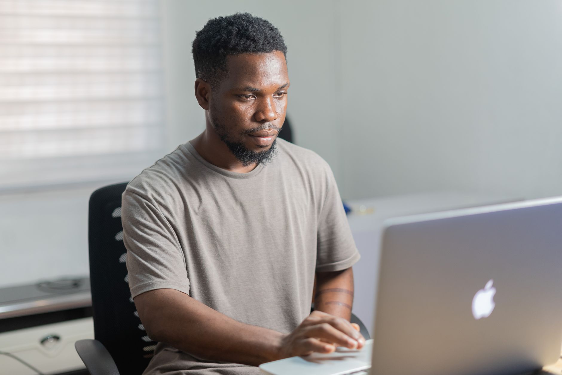 African entrepreneur using laptop to manage a digital business funded by diaspora remittances
