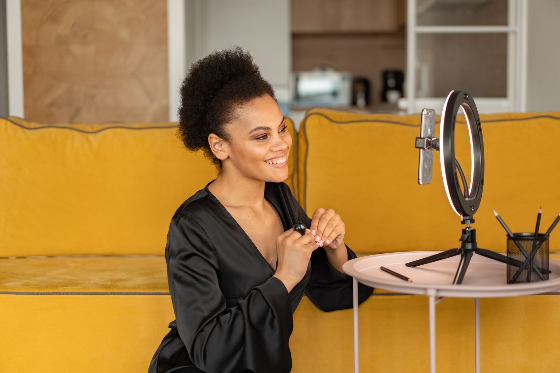 African content creator filming YouTube video in a home studio