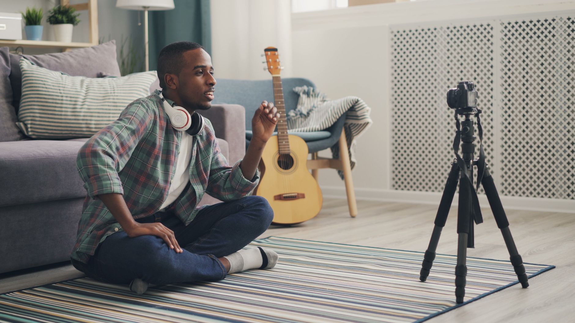 African content creator recording video on smartphone in a bright studio