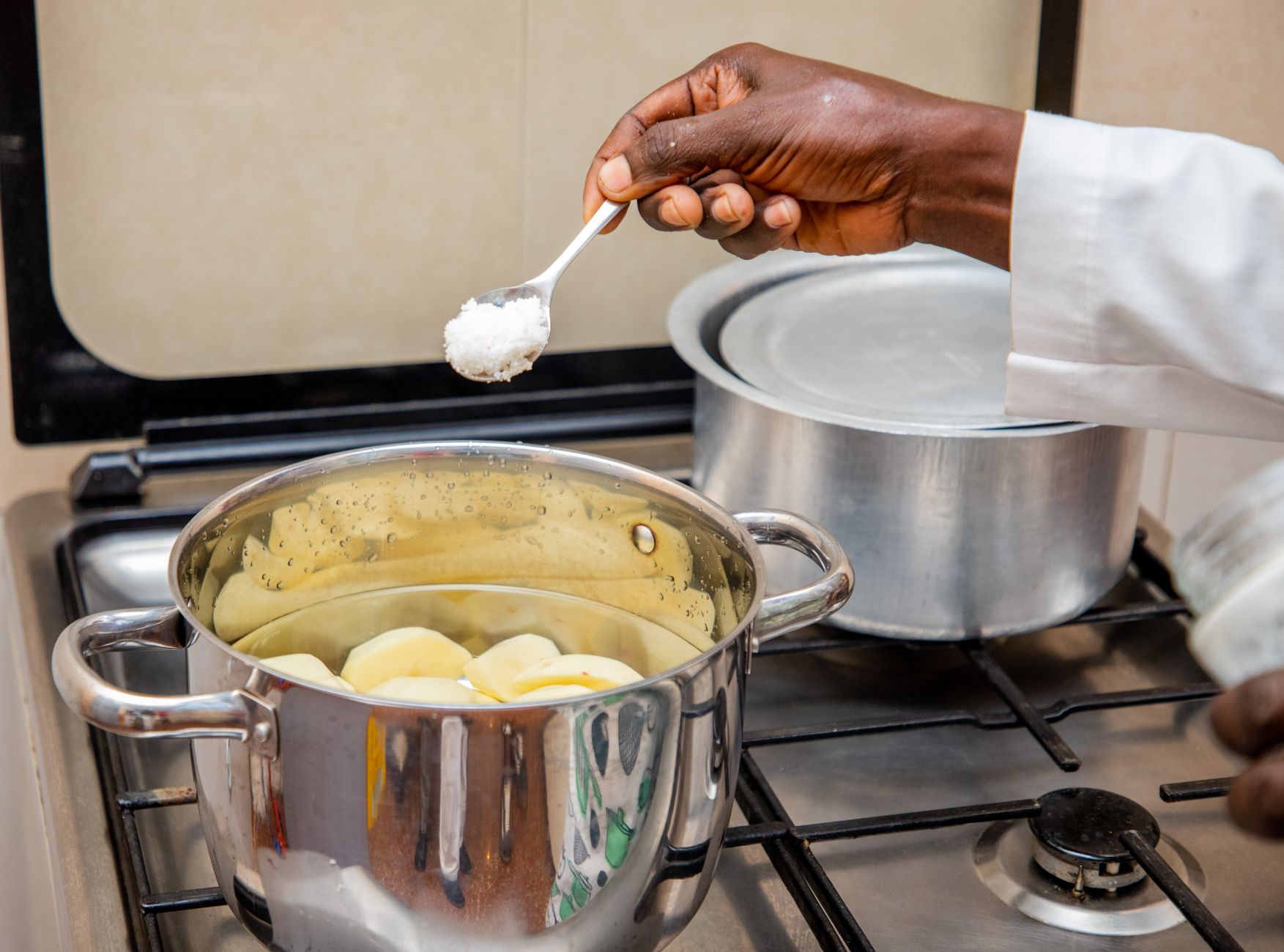 African diaspora food entrepreneur cooking traditional dishes in a modern kitchen