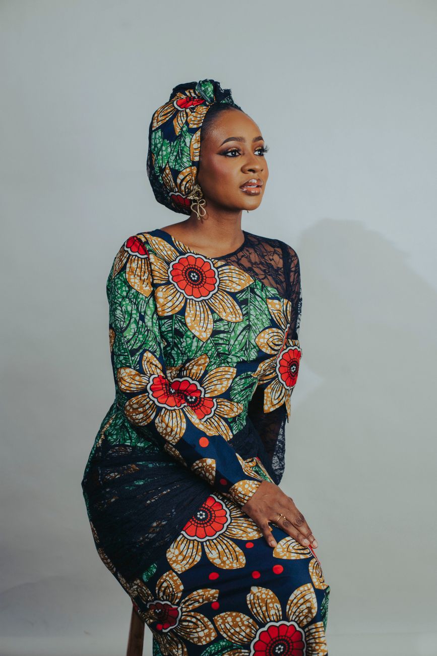 African diaspora fashion designer presenting colorful kente and ankara clothing line
