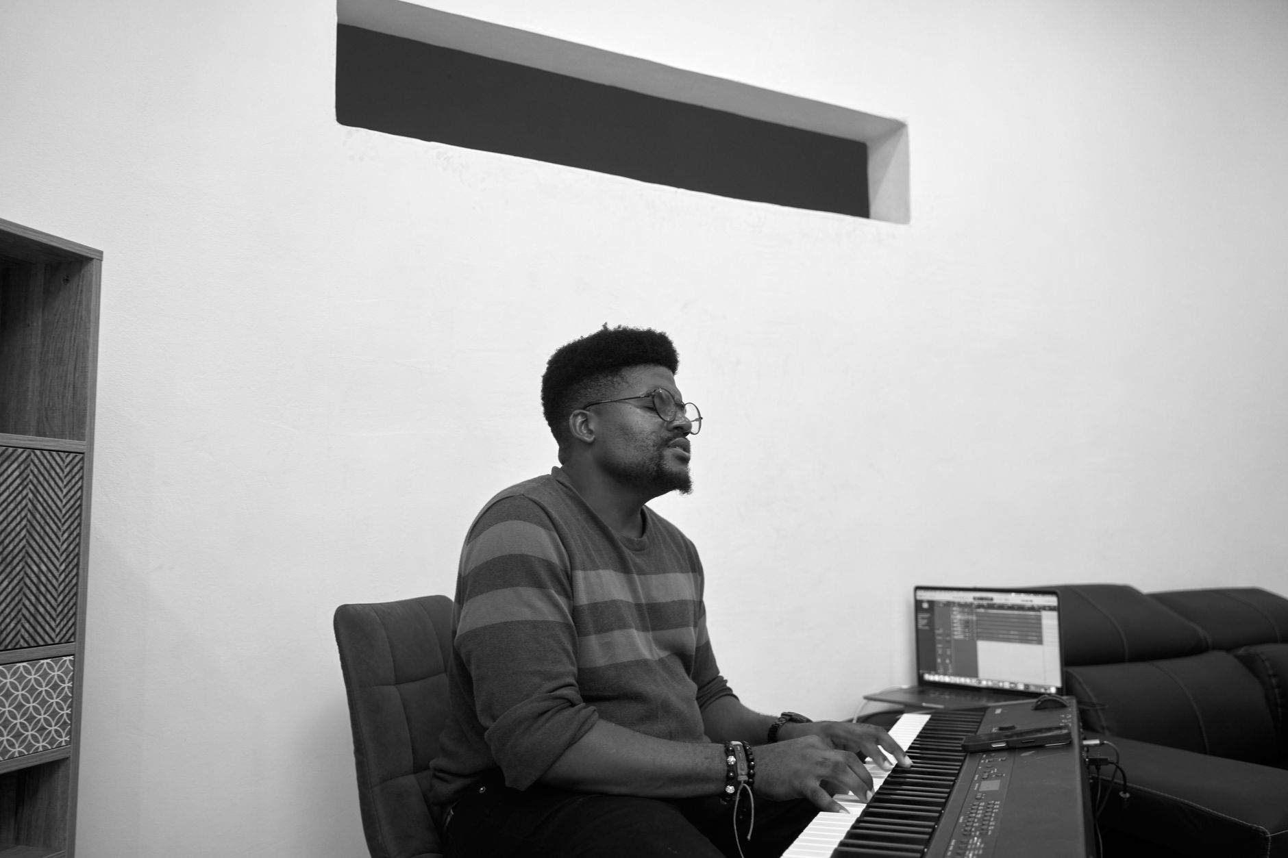 African creator recording music in a modern studio