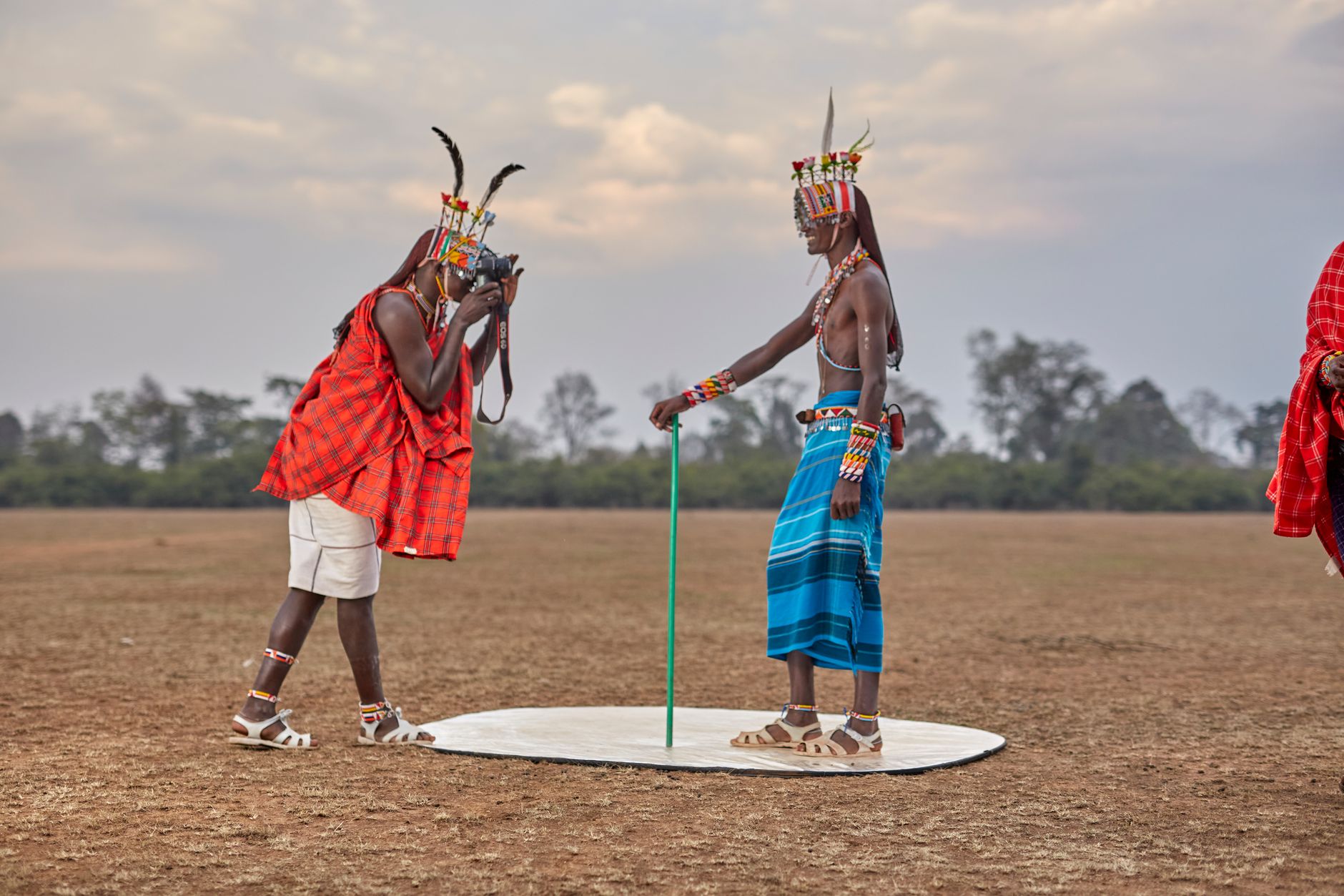 African photographer documenting traditional tribal ceremony in rural village