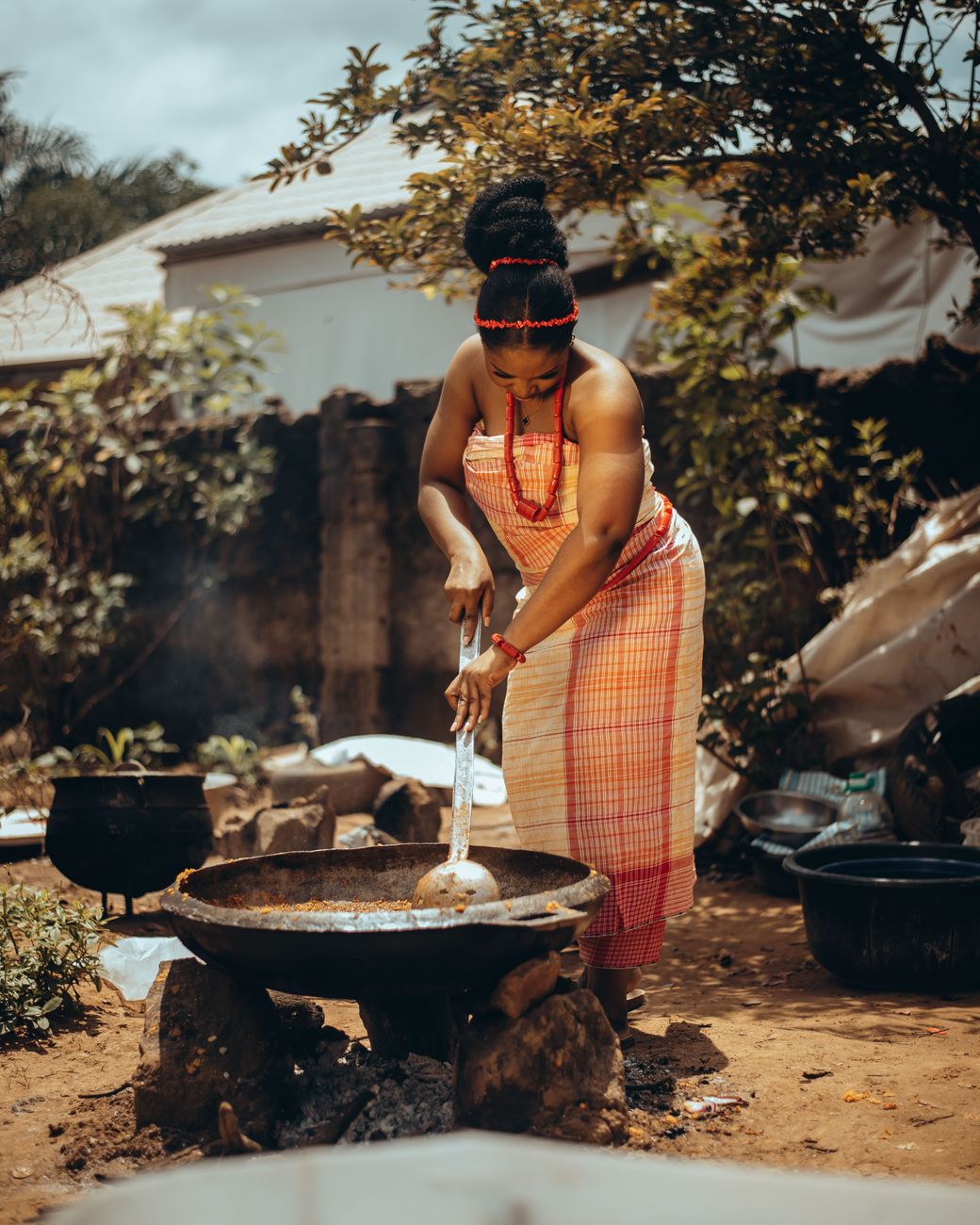 African food creator preparing traditional dish with ancestral cooking methods