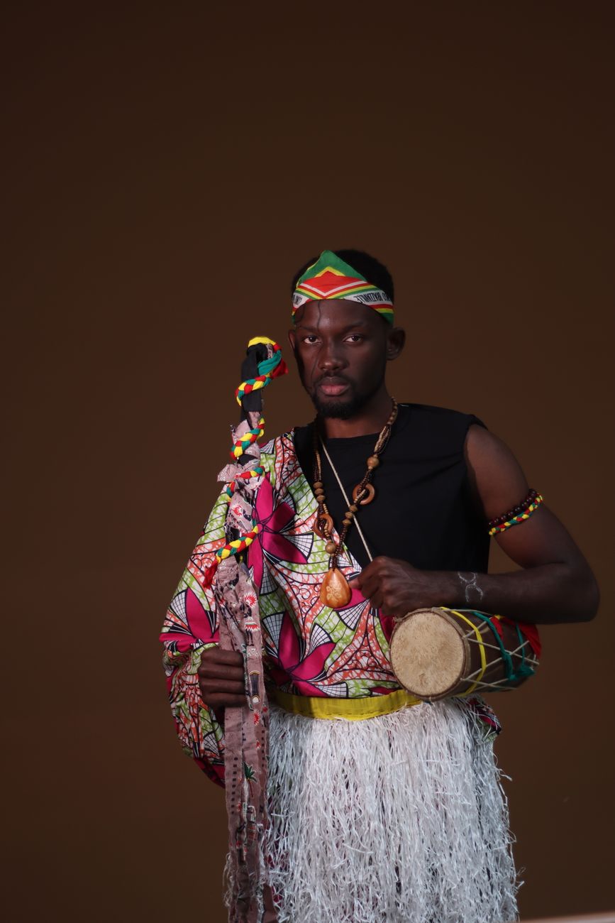 African music producer sampling traditional instruments in modern recording studio