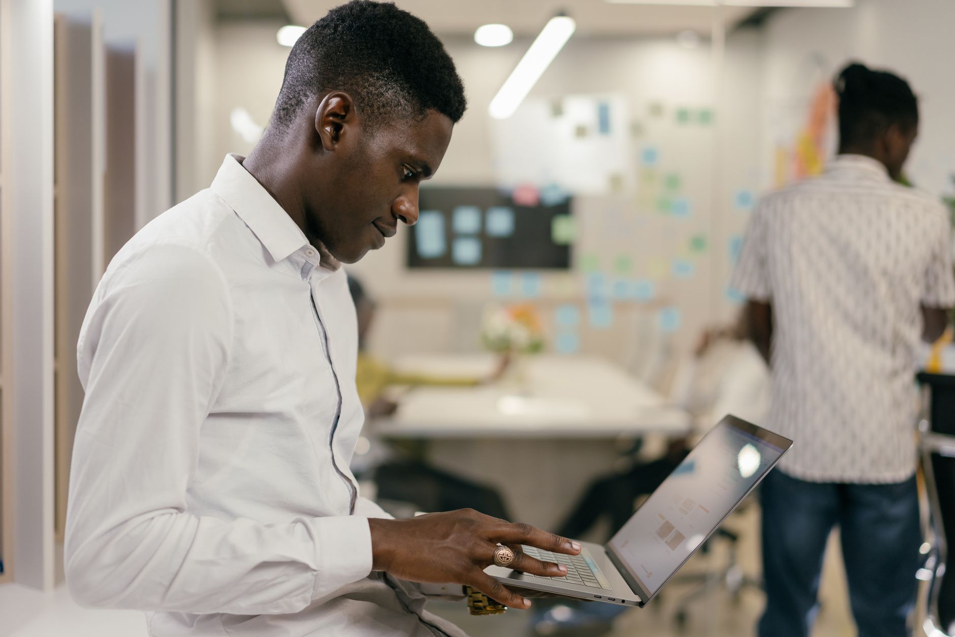 African tech innovators working on climate data dashboards in a modern hub