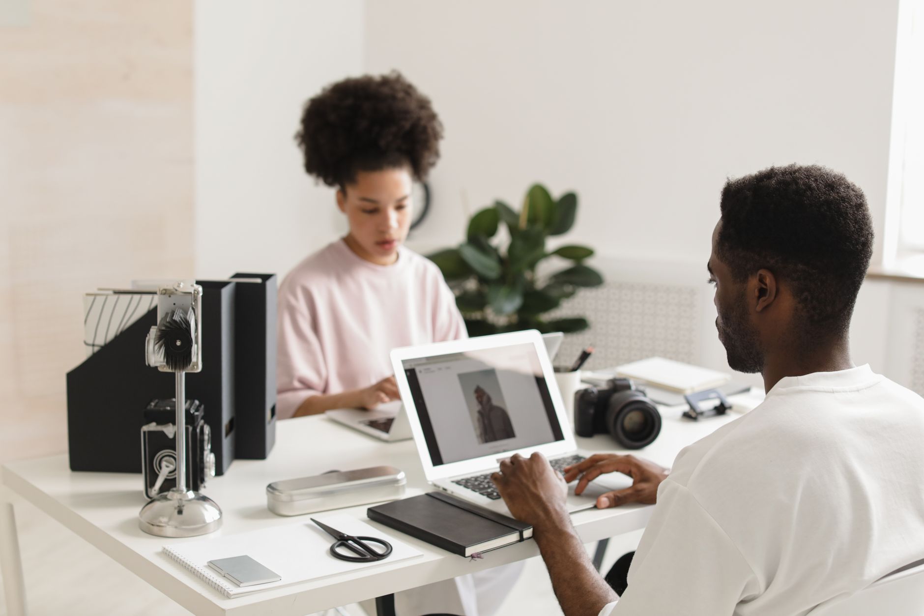 Creators working on laptops and design tablets inside a modern Nigerian tech hub