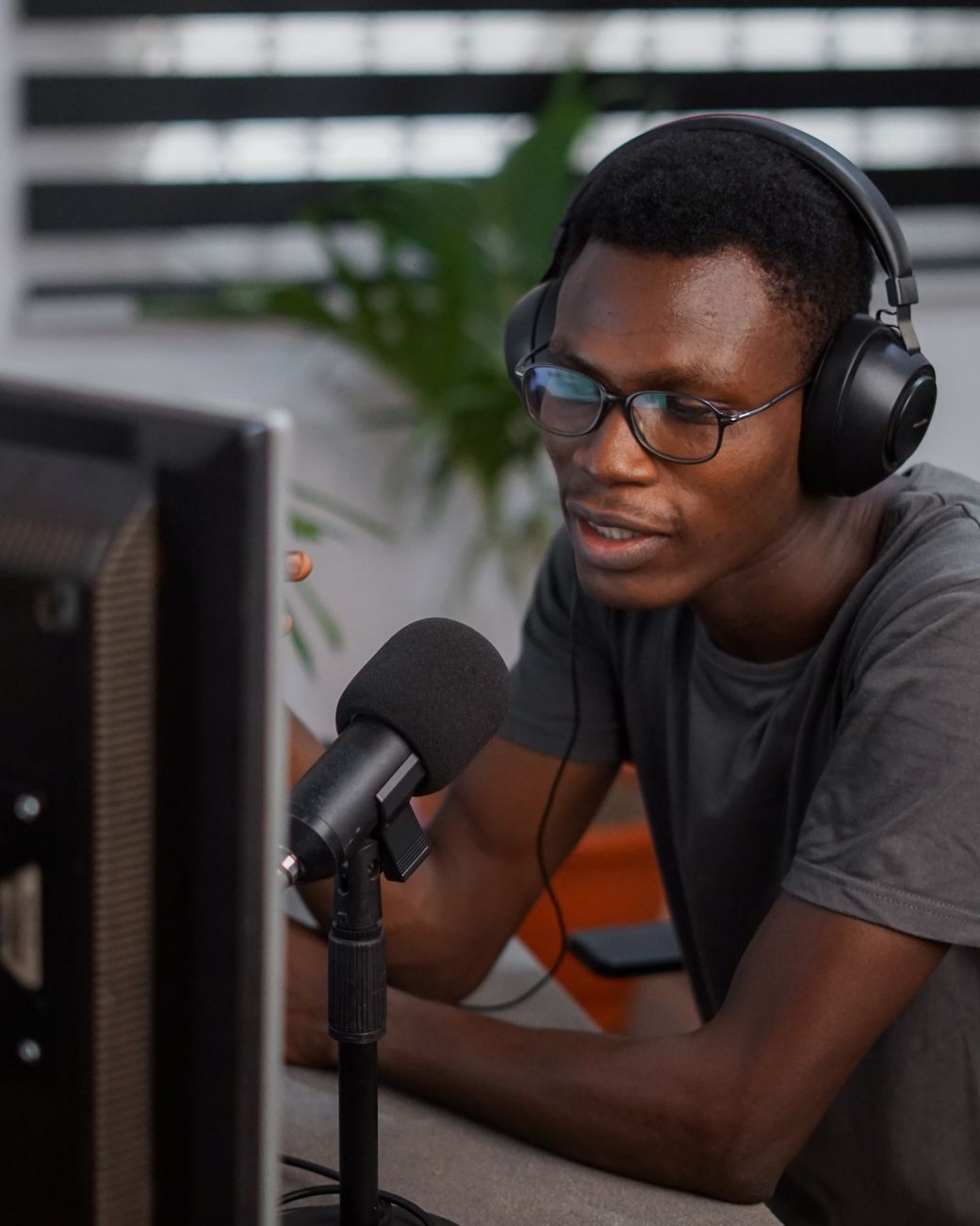 African podcast host recording in a professional audio studio