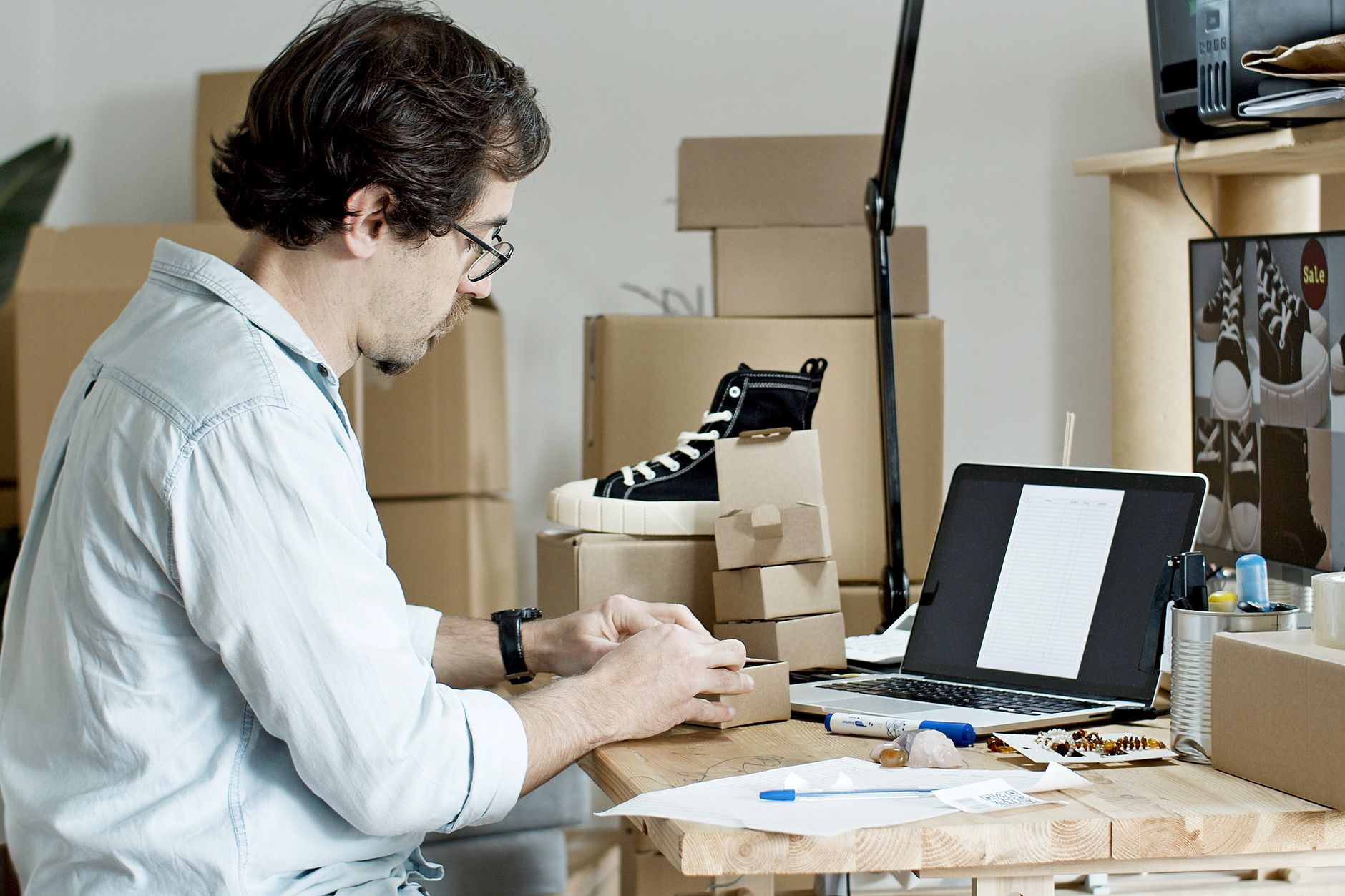 Entrepreneur setting up an online store on a laptop
