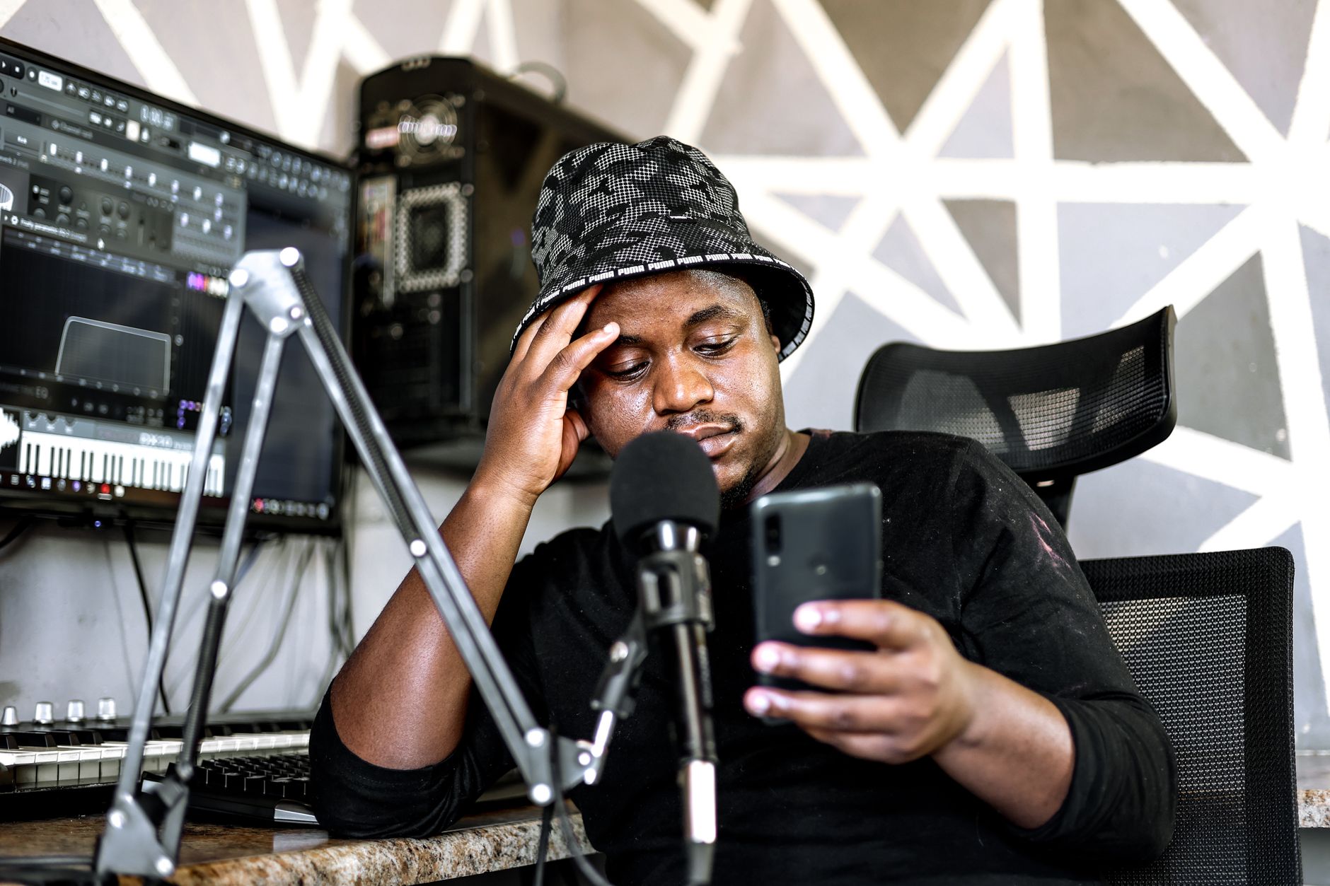 African musician recording music in a home studio