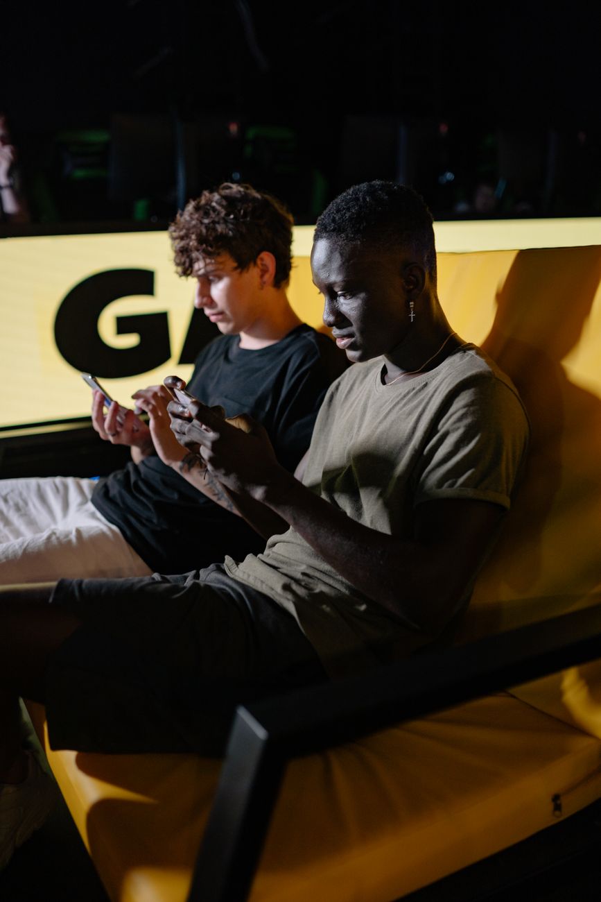 Young African gamers playing mobile games together