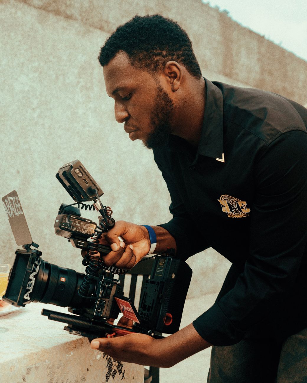 Nigerian sports content creator filming football highlight reel