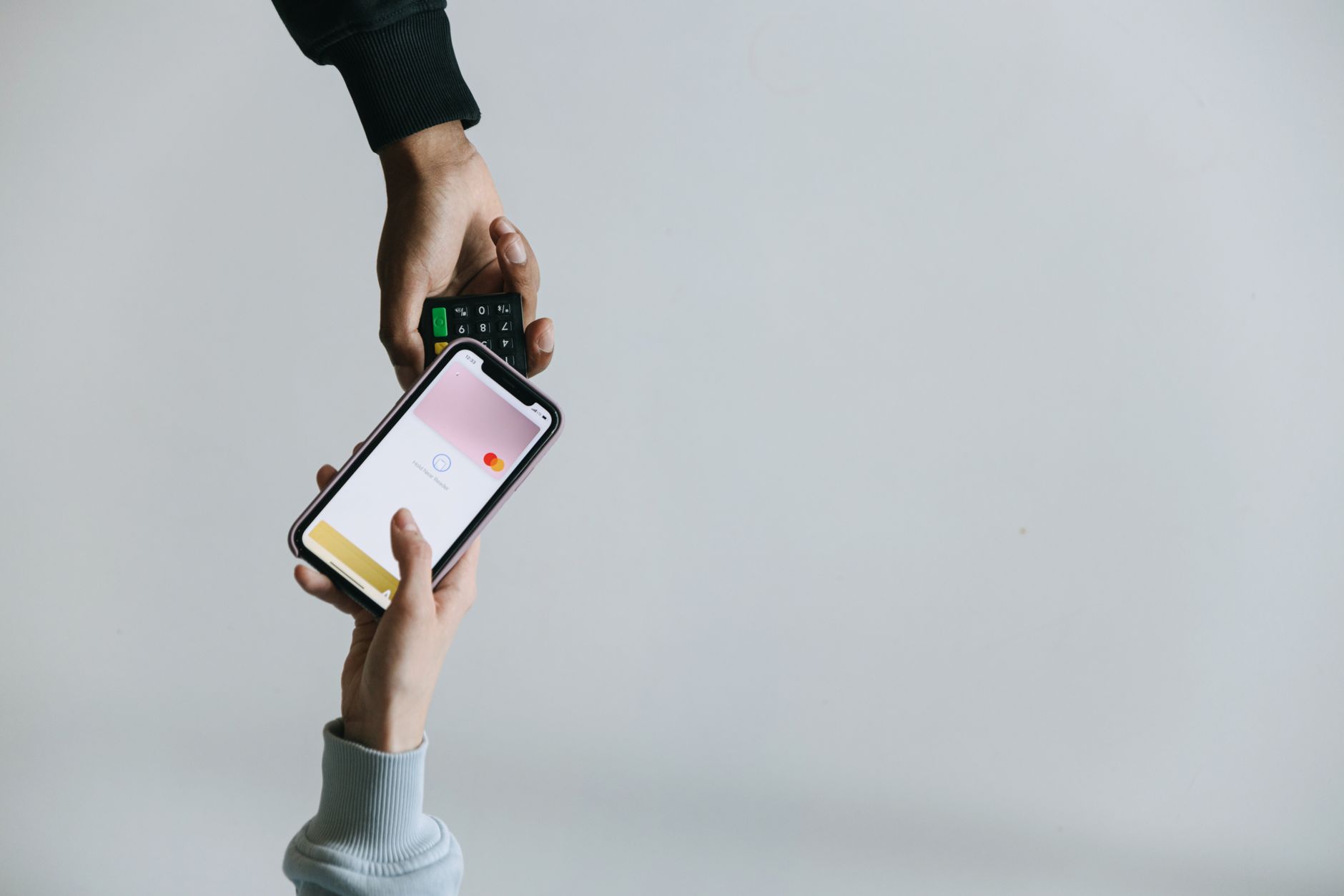 Young African woman using mobile payment app on smartphone