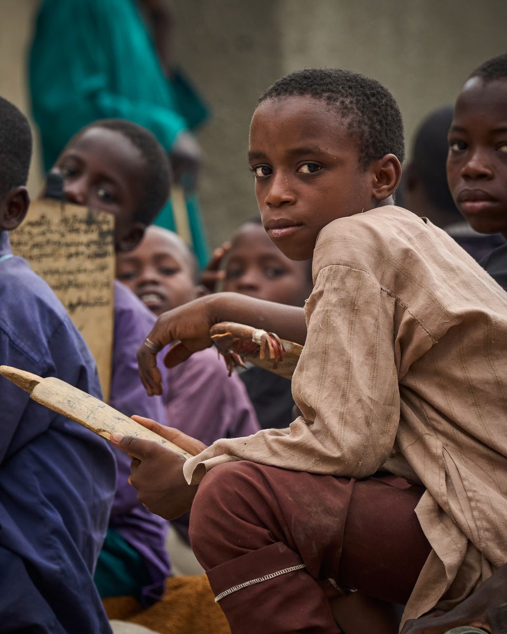 African children learning with educational tablet app in classroom