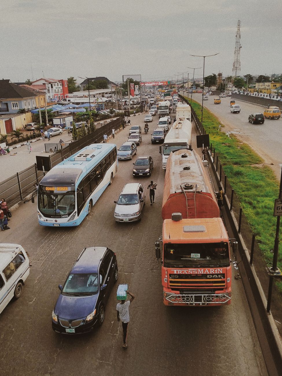 African commuters boarding a modern shuttle bus in Lagos city
