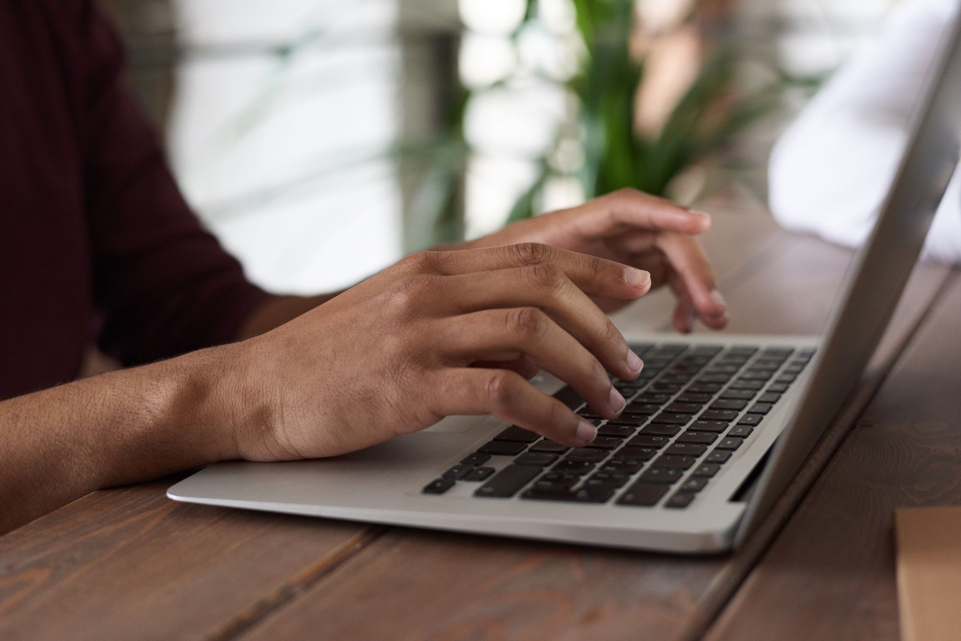 Person writing a newsletter on a laptop with African city skyline in background