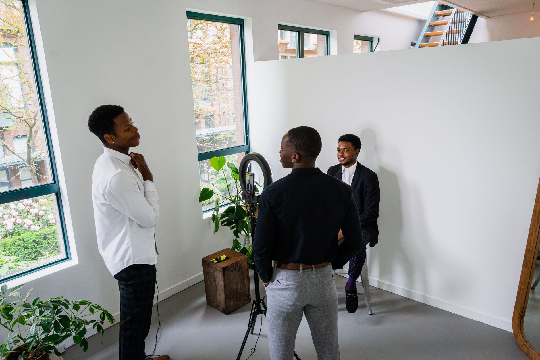 Small African content studio team reviewing video footage on monitor