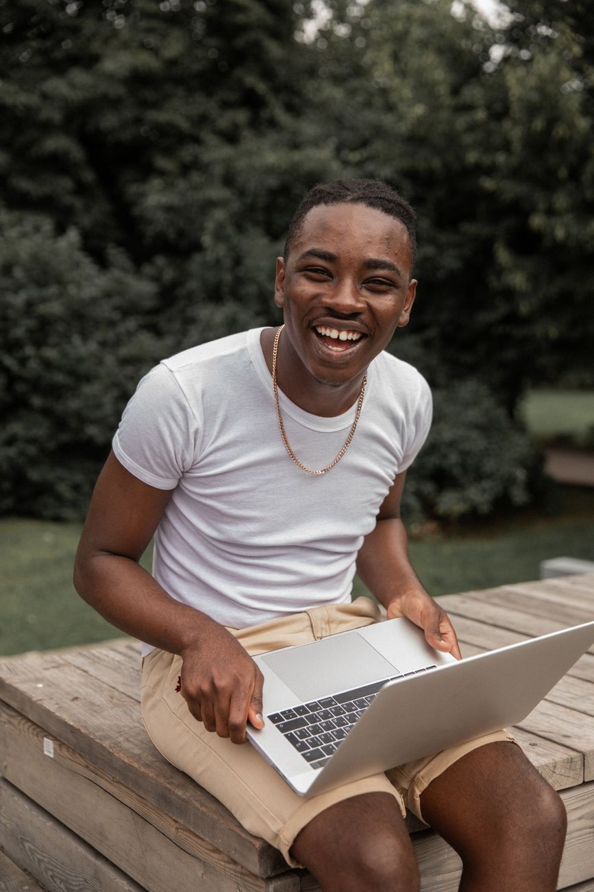 African content creator optimizing social media profile settings on a laptop