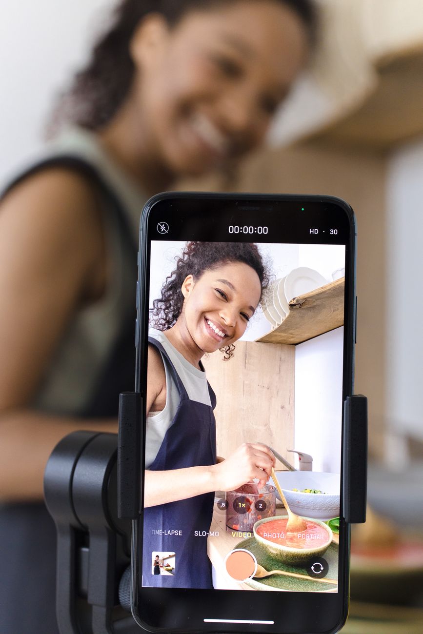 African creator filming content on smartphone for TikTok and Instagram