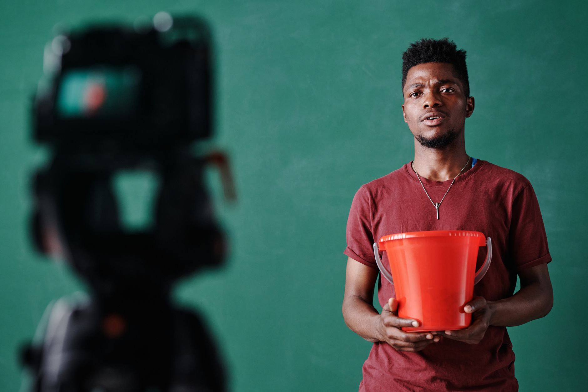 African content creator filming video in studio with ring light