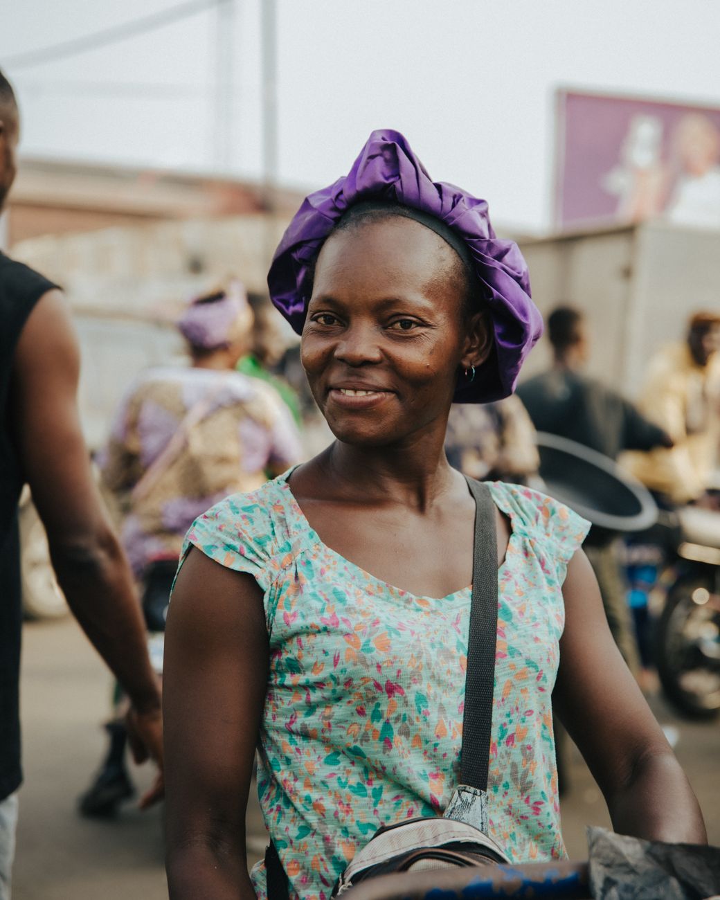 African travel vlogger filming in a vibrant African city market