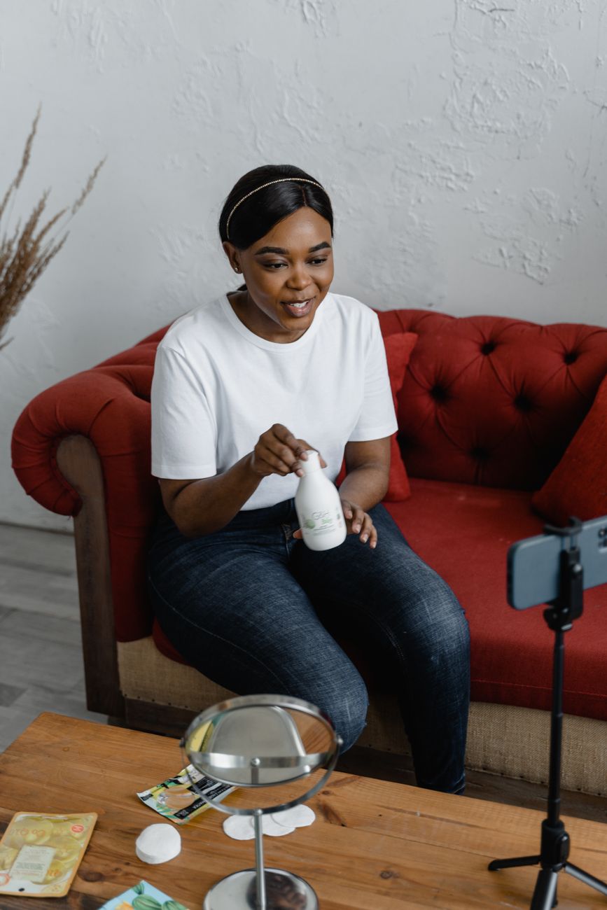 Young African diaspora creator filming lifestyle content with handmade African goods