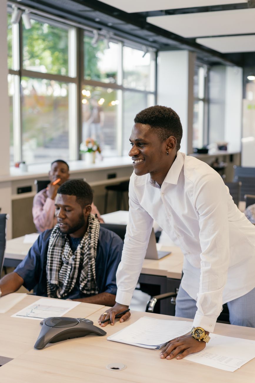 African tech hub co-working space with young creators working on laptops