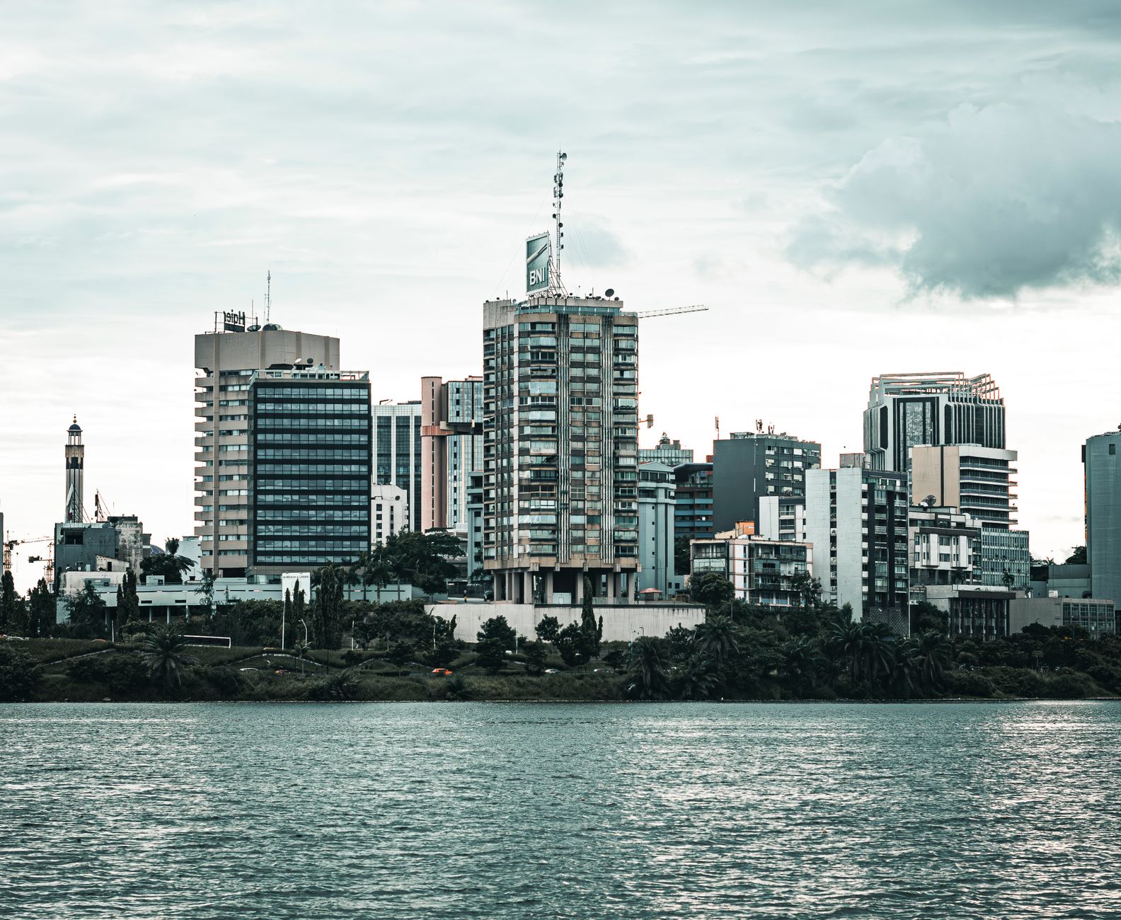Abidjan Ivory Coast skyline with modern business district and lagoon