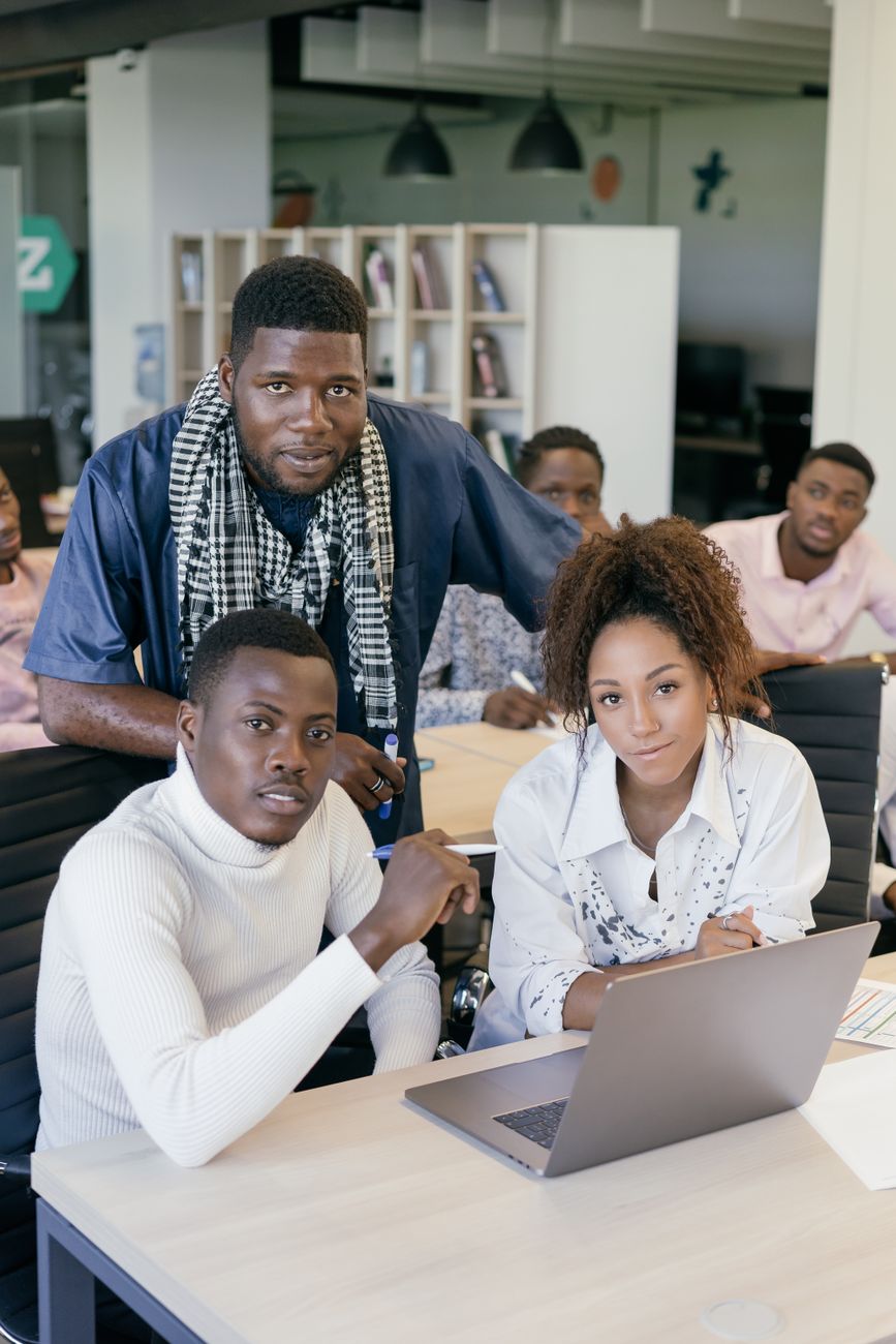 African tech entrepreneurs collaborating on digital creator tools in a modern workspace