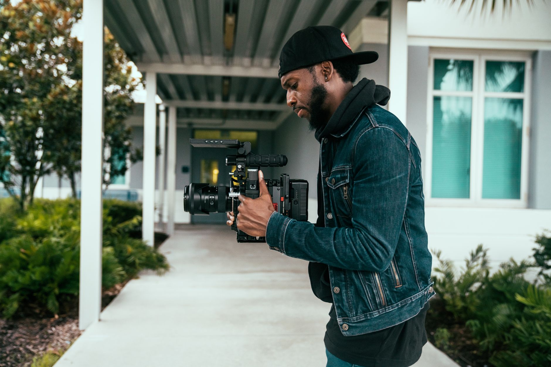 African content creator filming video for digital audience with camera and ring light