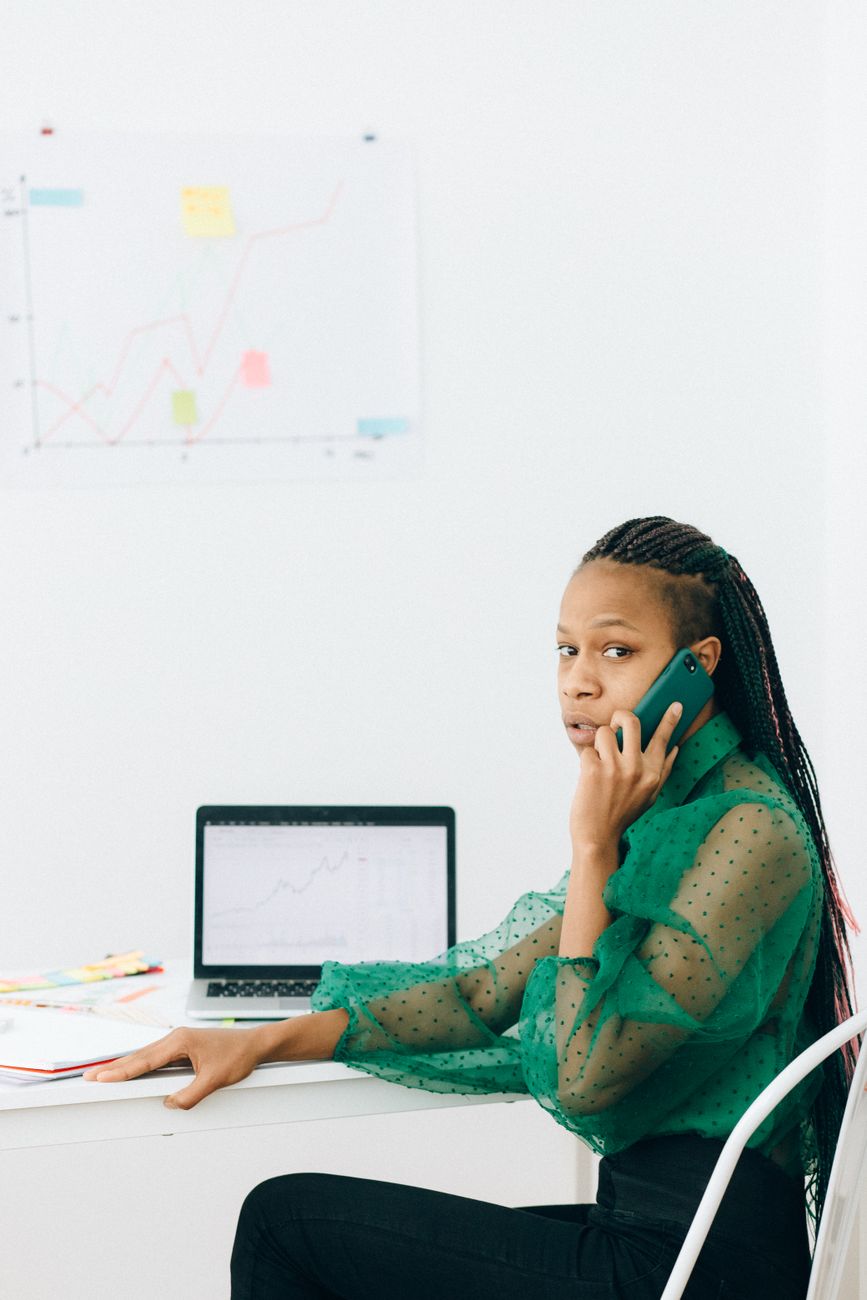 African entrepreneur reviewing startup data on laptop