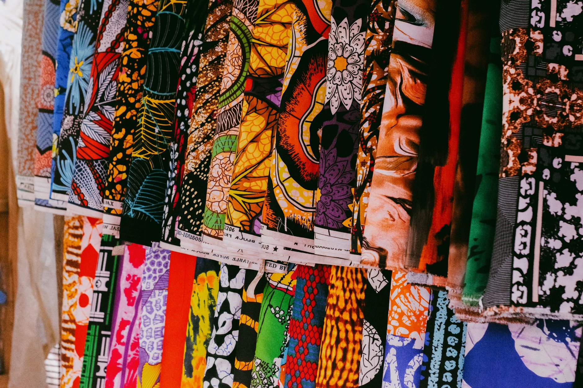 Colorful African fashion items laid out for resale marketplace