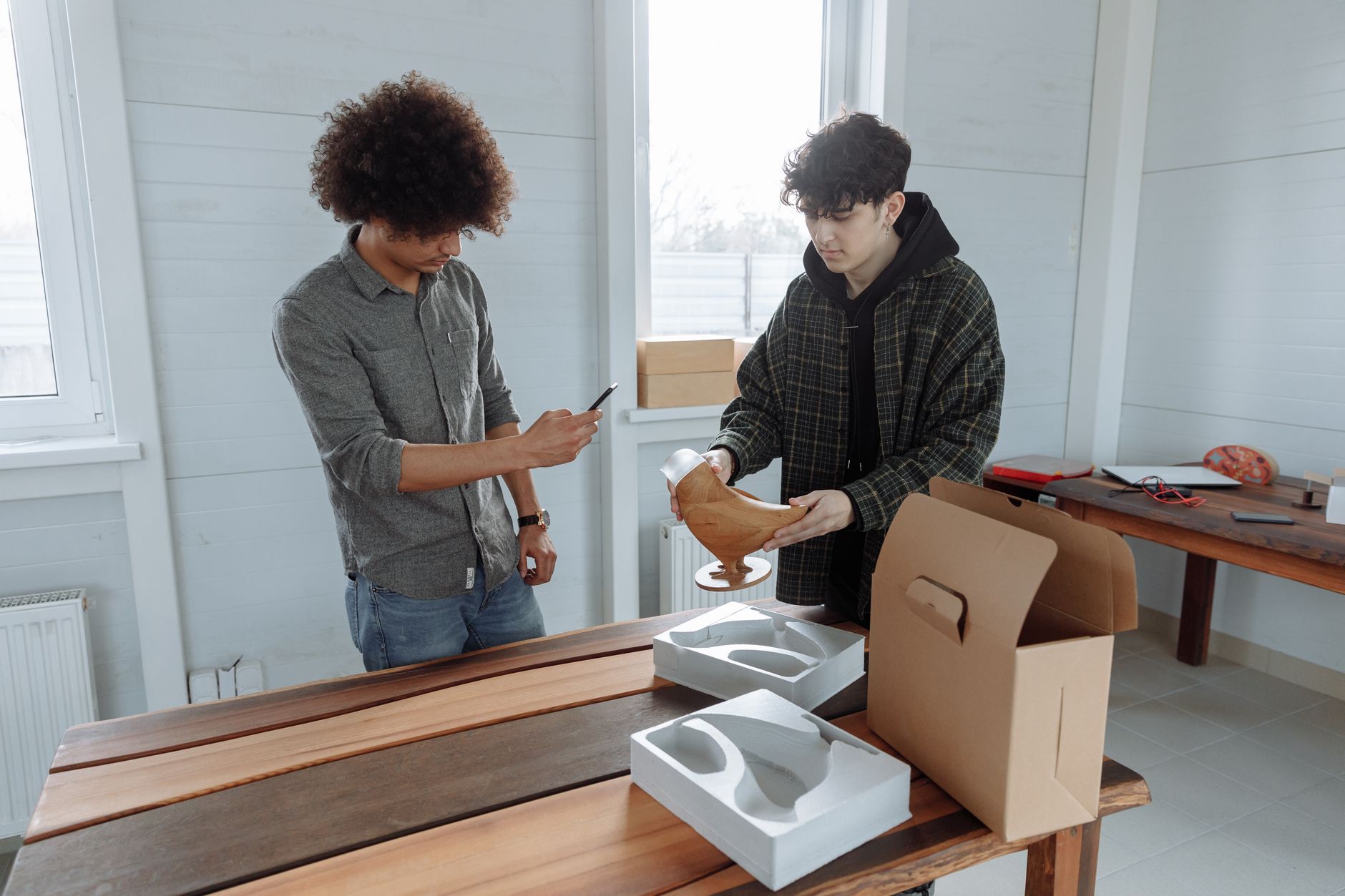 African small business owner packaging products for international shipping