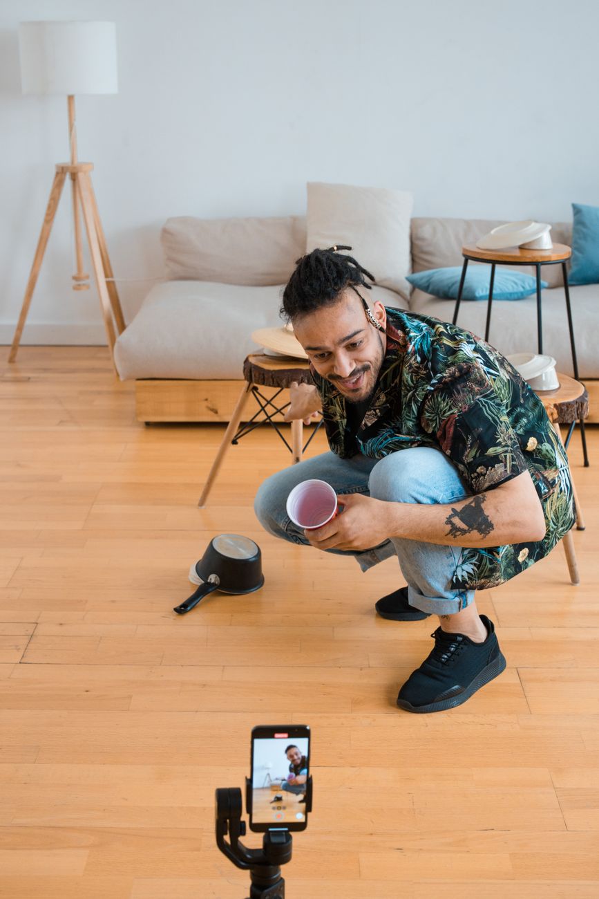 African creator filming content on smartphone for Facebook and Instagram