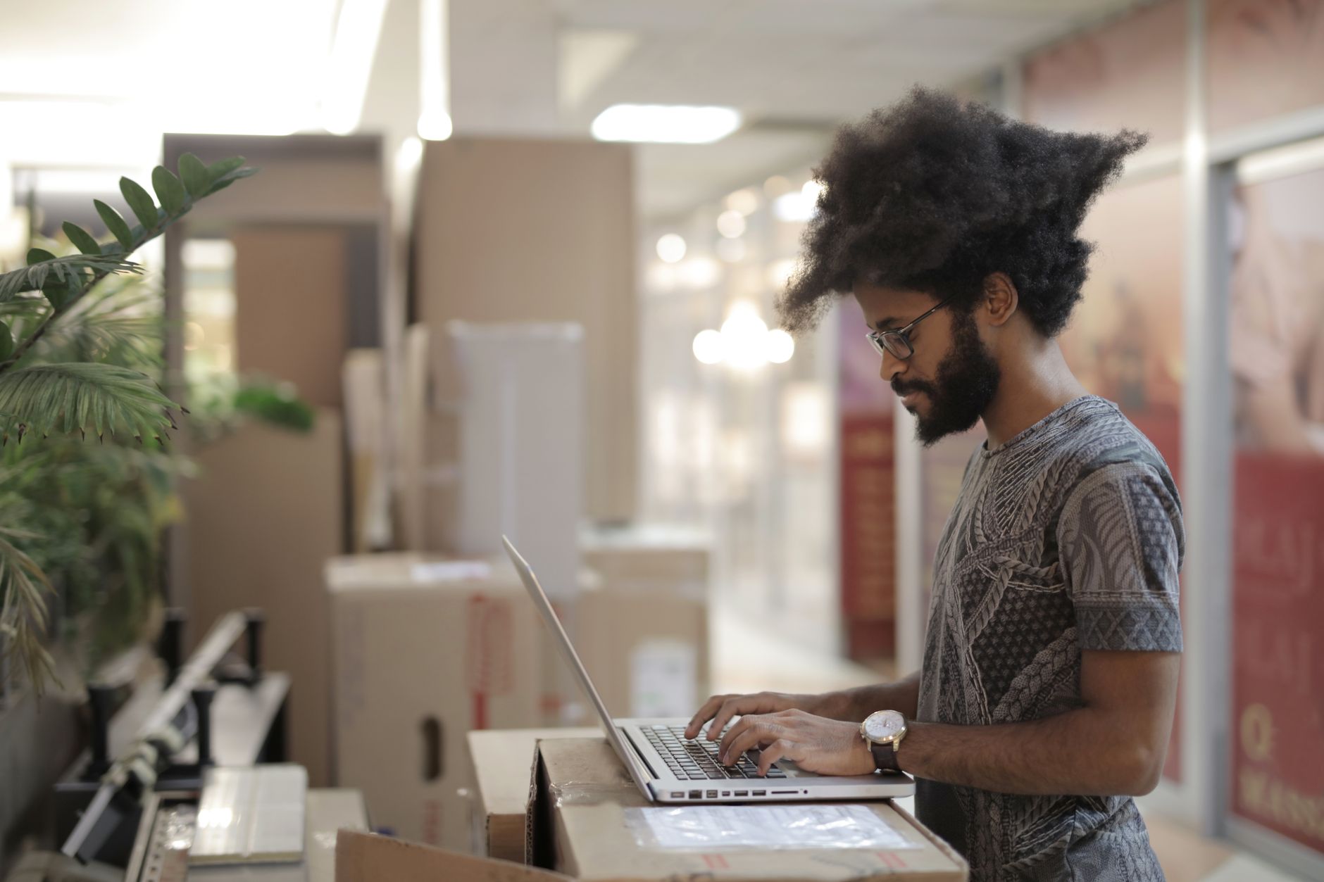 African entrepreneur using laptop to manage social media business profile