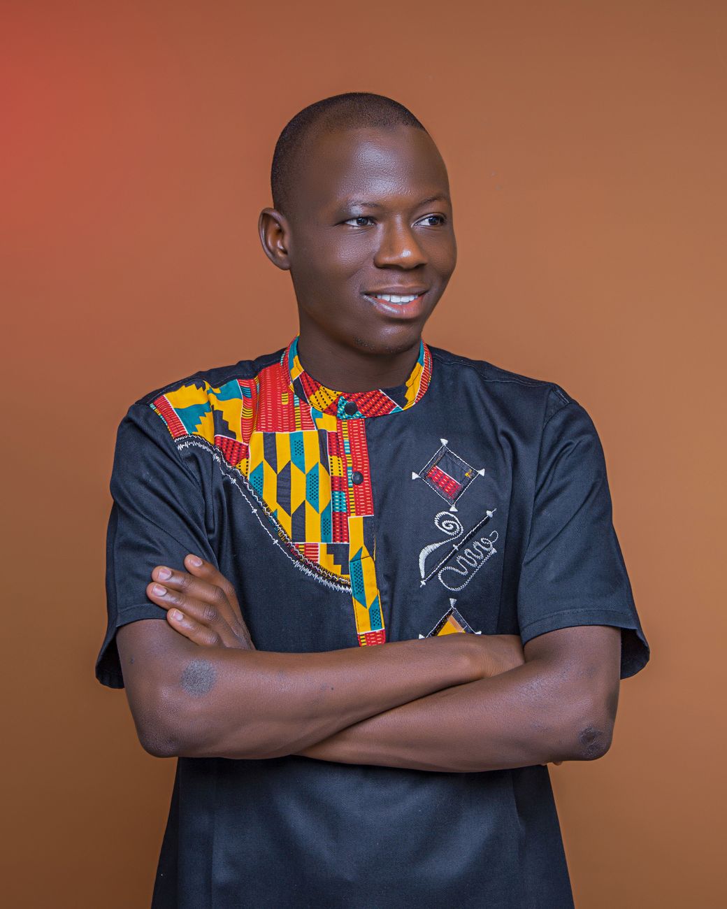African diaspora fashion designer working on kente fabric streetwear collection