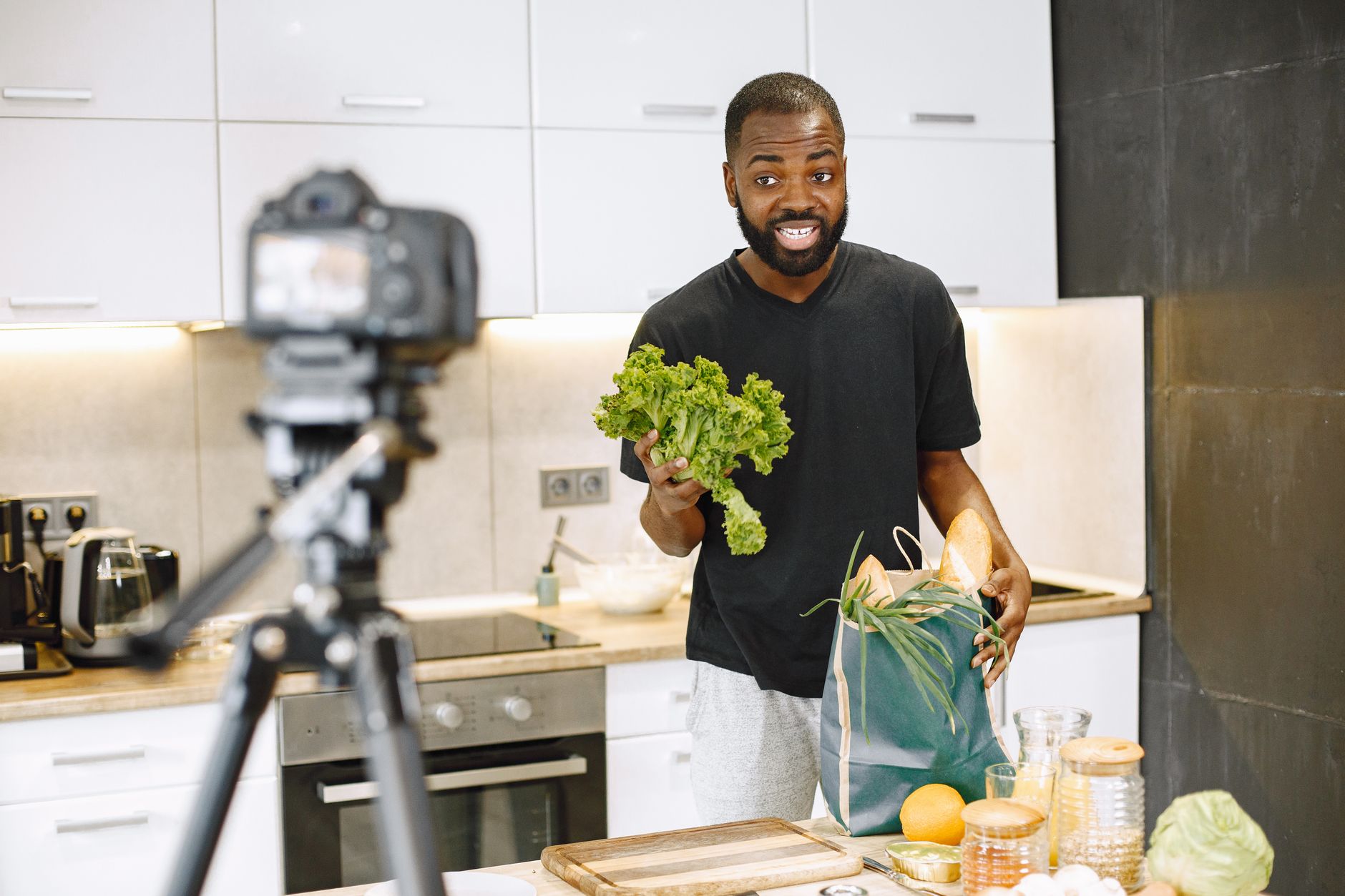 African creator filming product content for social media on smartphone