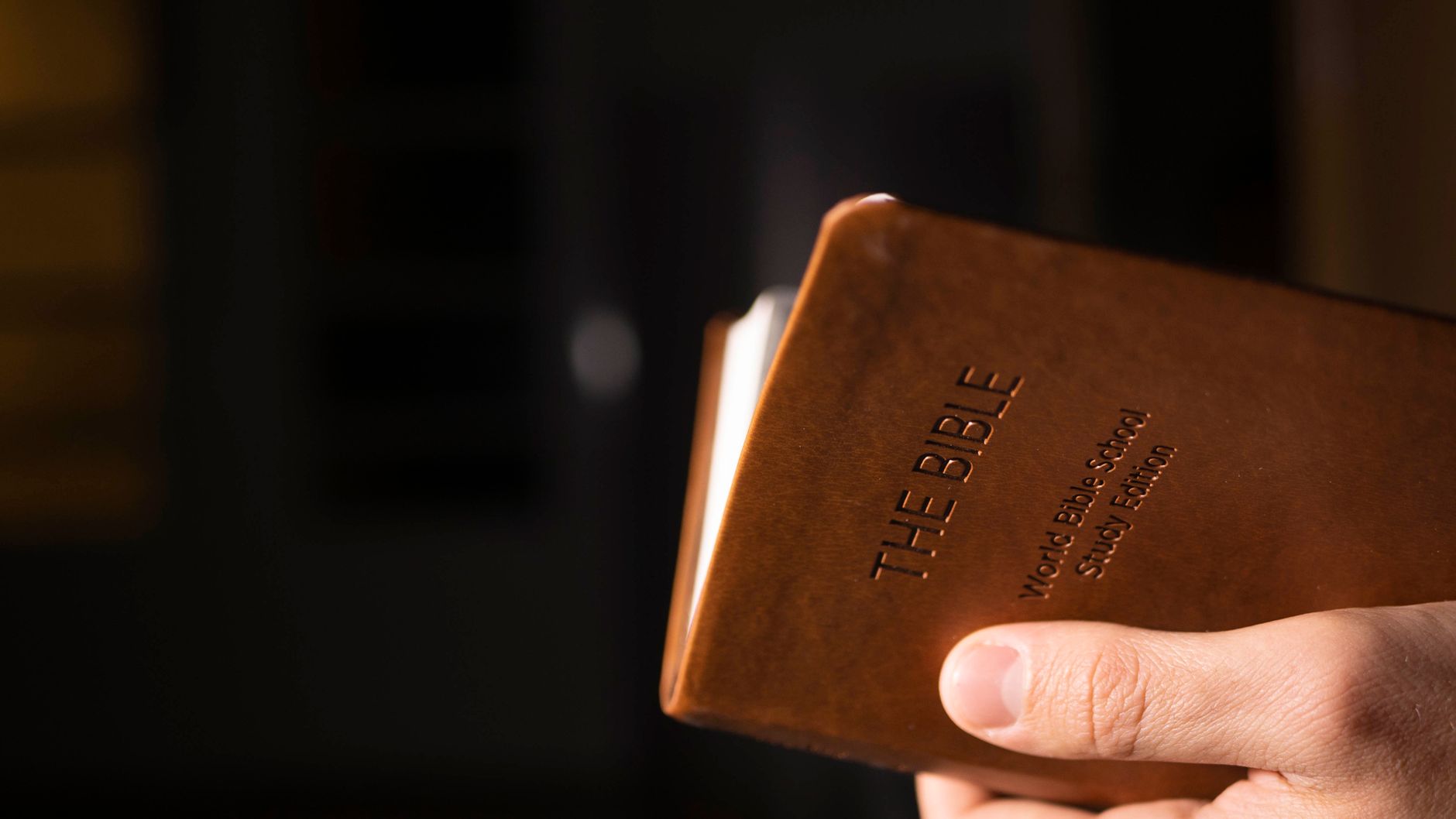 High school student with open Bible and study materials
