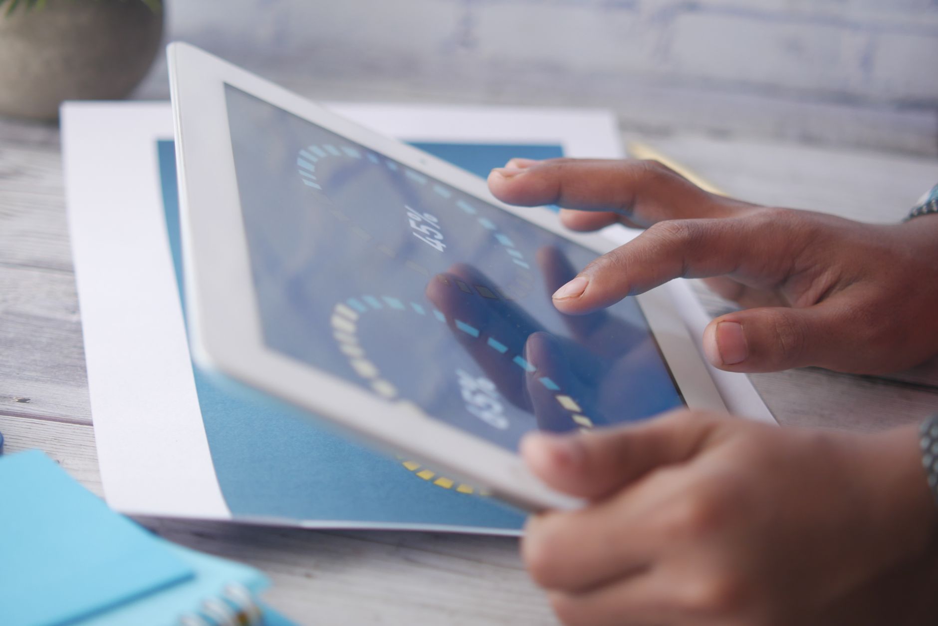 Person studying Bible with a tablet showing cross reference connections