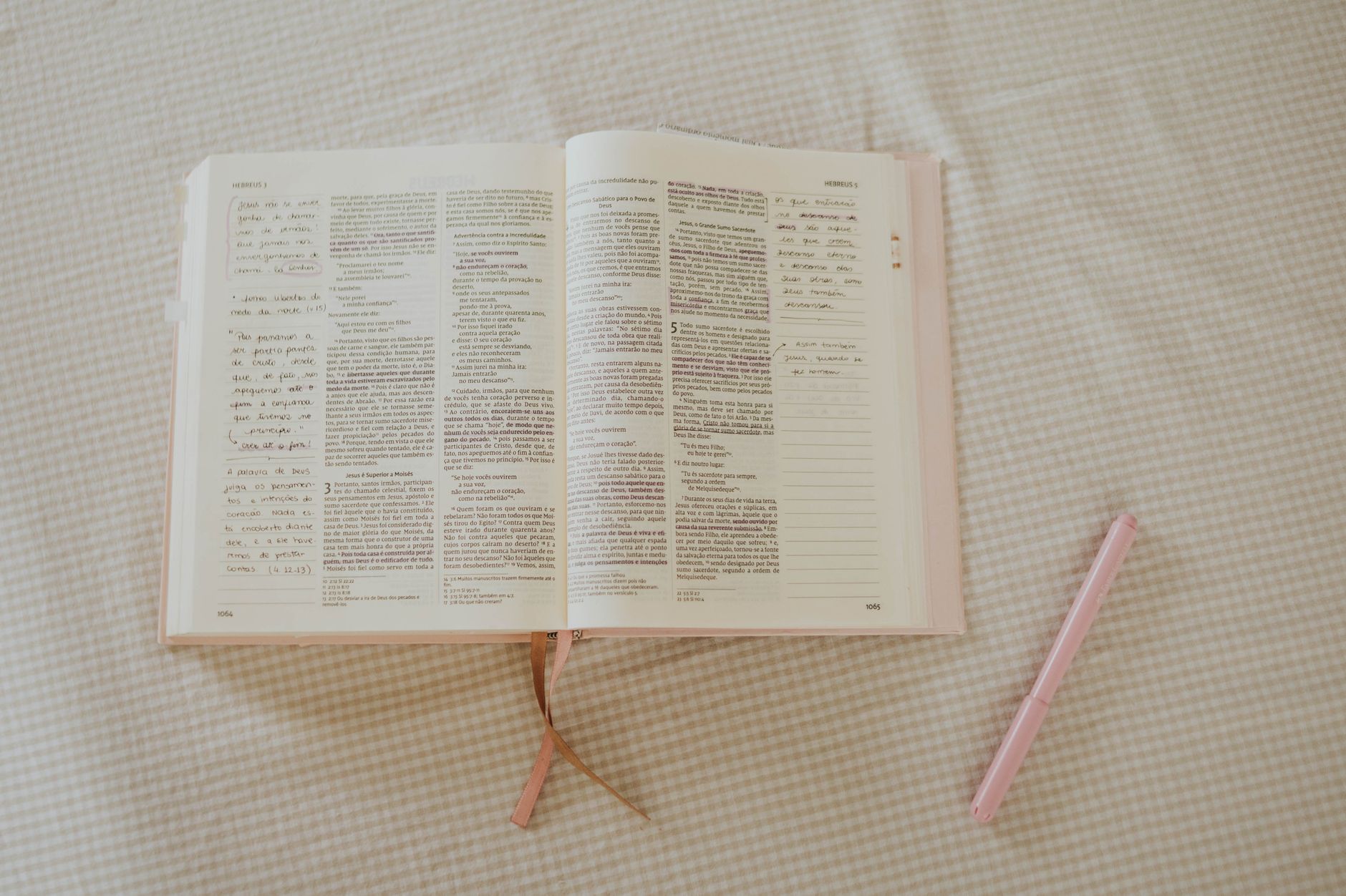Open Bible with study notes and highlighters on a wooden desk