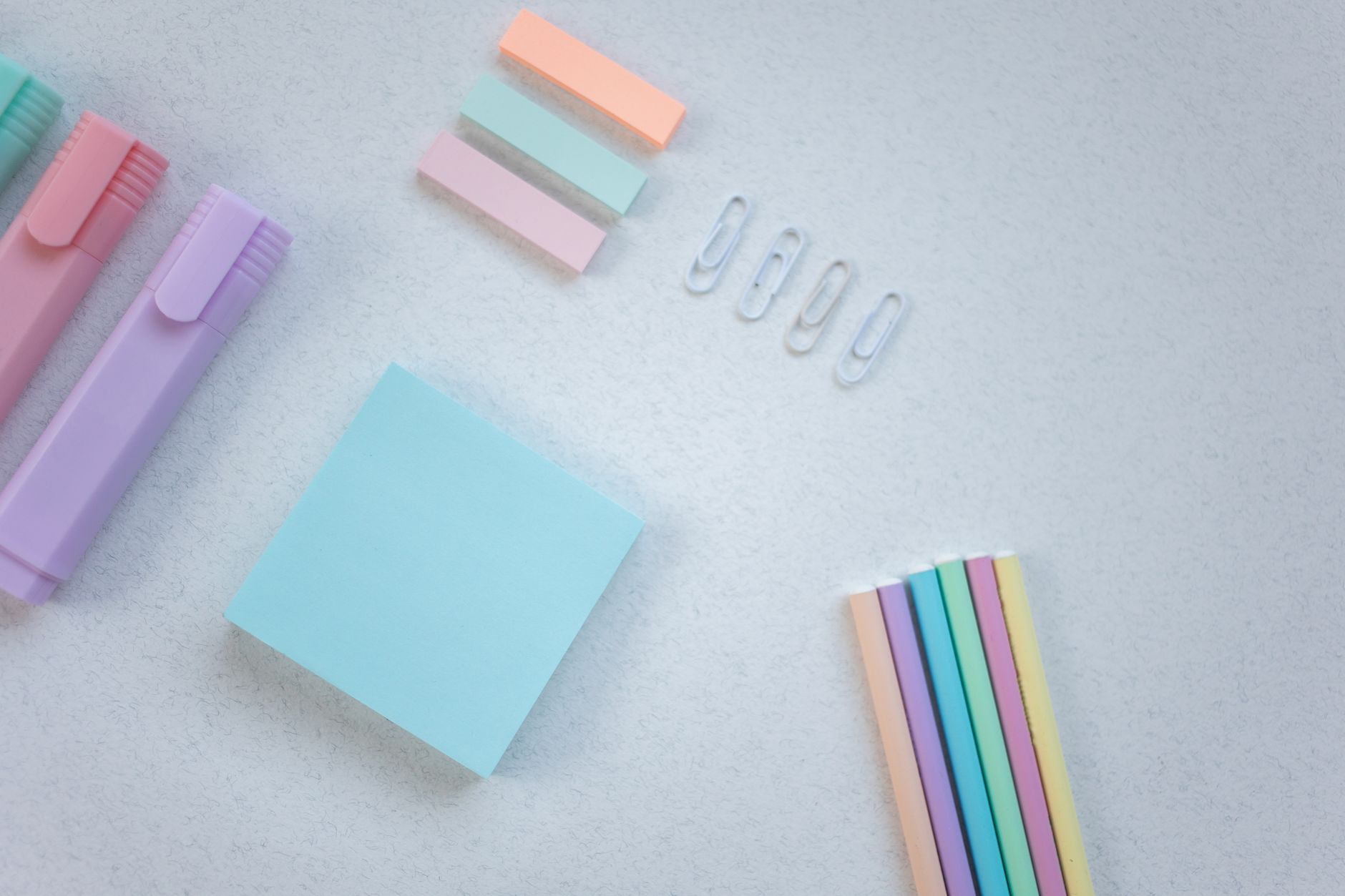 Person tracing a Bible theme across Old and New Testament pages with sticky notes