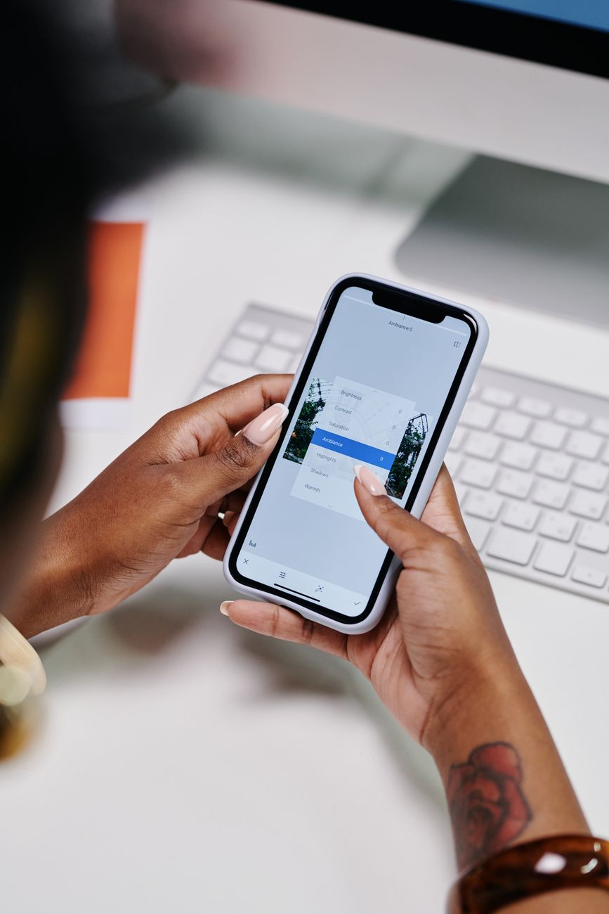 Person using a Bible study app on a smartphone with cross reference features