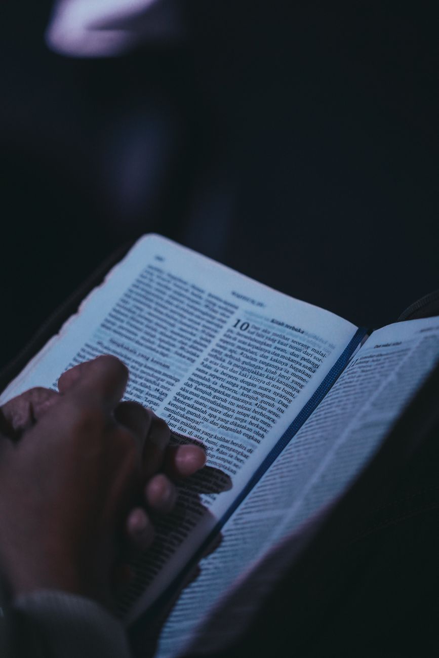 Person using Android smartphone to study the Bible with a coffee cup nearby