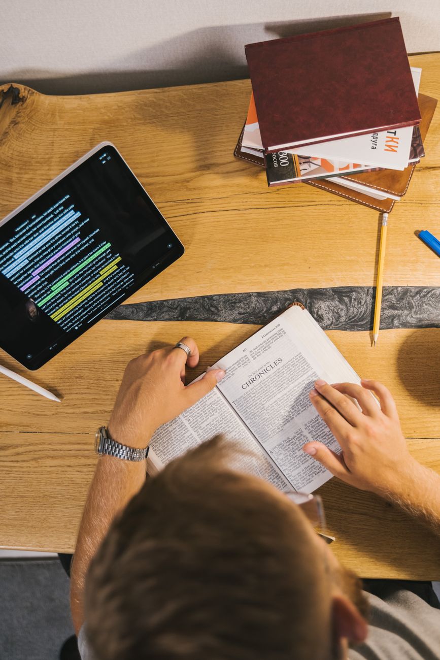 Open Bible with highlighted verses and cross-reference notes in the margins