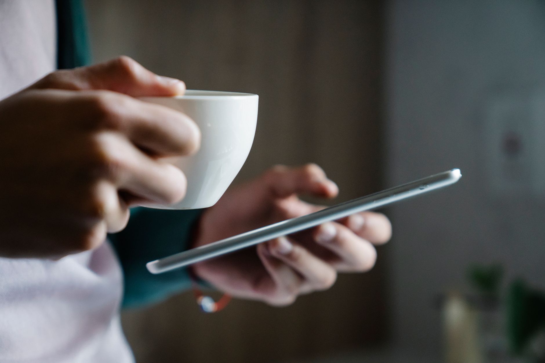 Person reading Bible on smartphone with cross-reference feature highlighted on screen