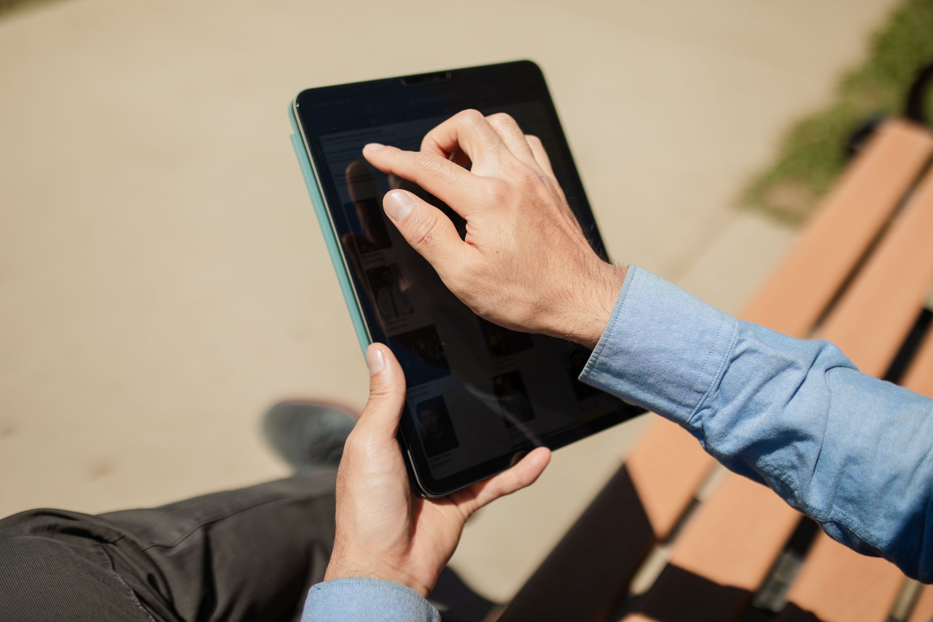 Person studying the Bible on a tablet app with notes and a coffee cup